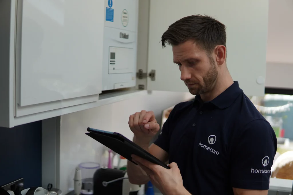 Homecure heating engineer in [city] servicing a boiler