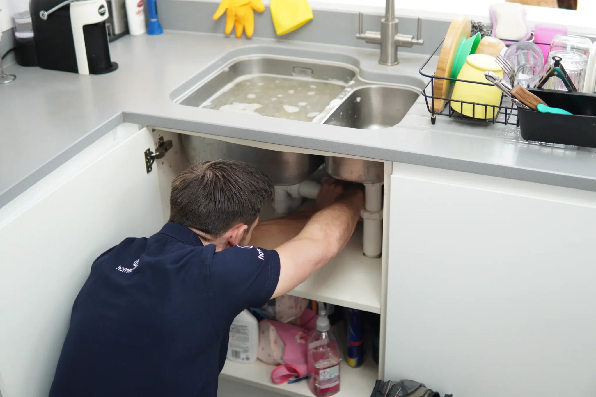 Plumber fixing a leaking sink in Wood Green