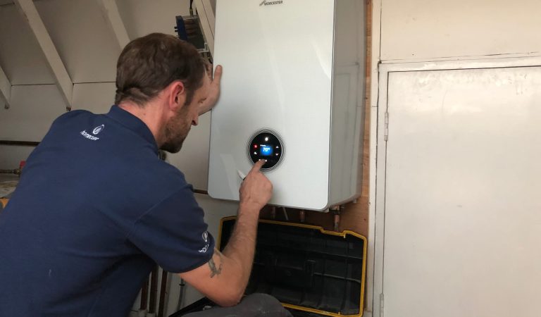 Homecure engineer adjusting a boiler in Tufnell Park