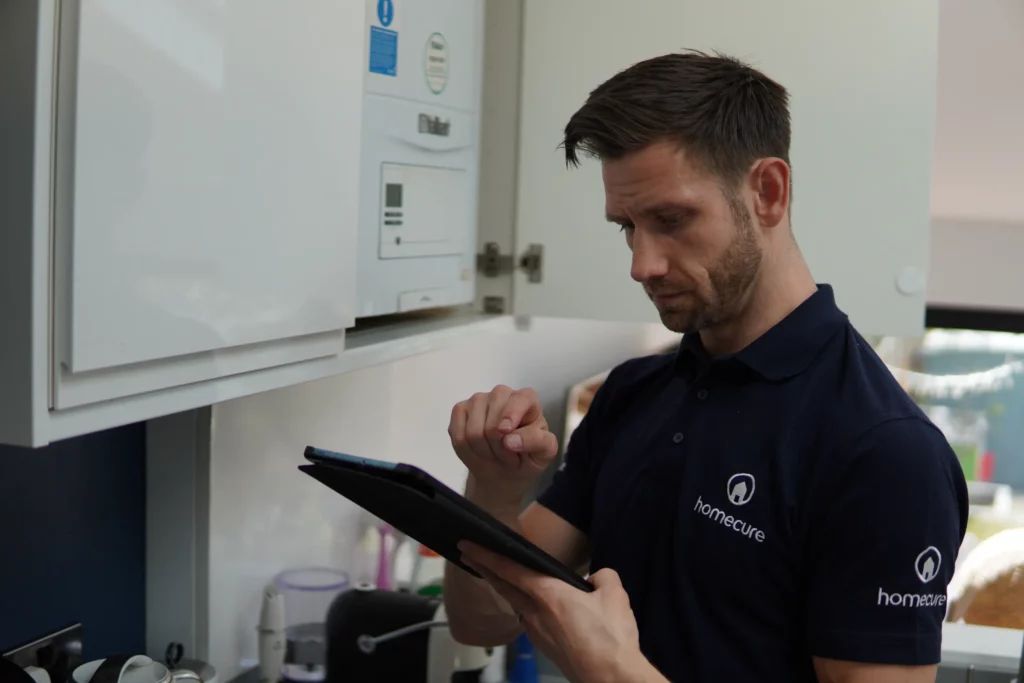 Homecure heating engineer in St Albans servicing a boiler