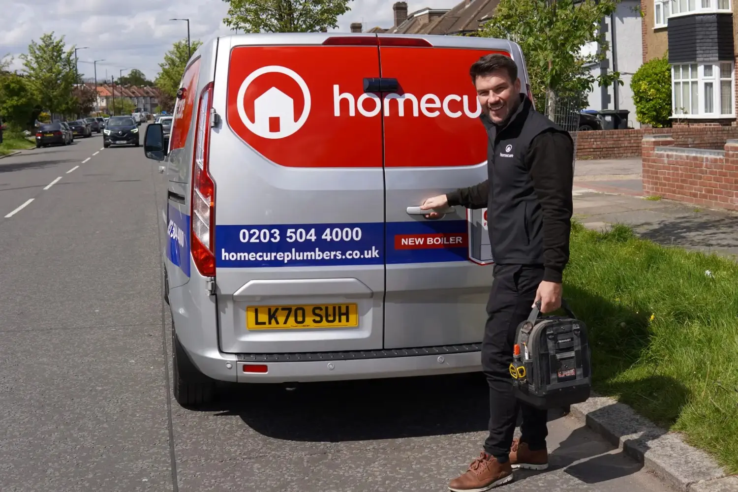 Homecure plumber next to a van in dulwich